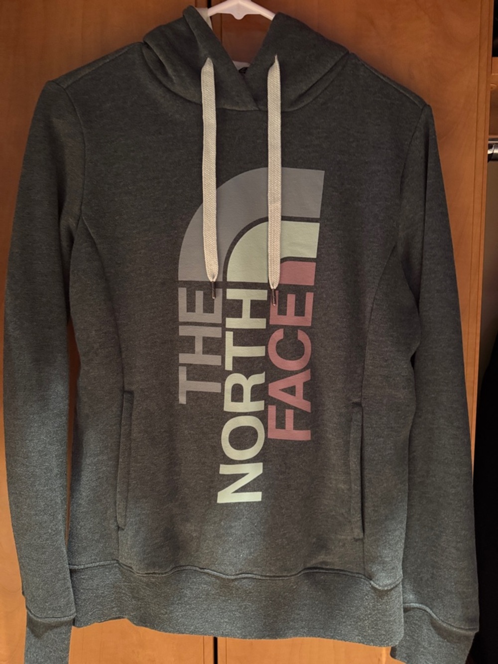 The North Face Dark Green Hoodie with Pale Green and Muted Pink Logo